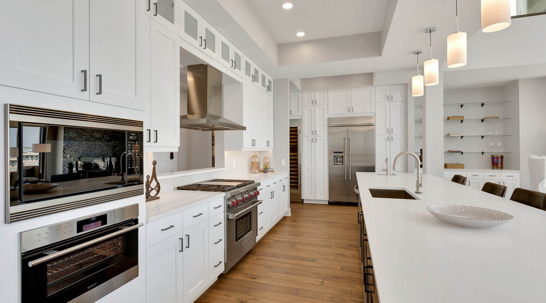 Kitchens with designer finishes  Kitchen with wood floors and white cabinets