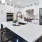 a kitchen with white cabinets and large island at The Pullman Apartments in Denver, CO near Union Station