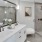 a bathroom with a glass shower and double vanity at The Pullman Apartments in Denver, CO near Union Station