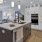 a kitchen with white cabinets and large island at The Pullman Apartments in Denver, CO near Union Station