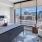 a bedroom with a view of the city at The Pullman Apartments in Denver, CO near Union Station